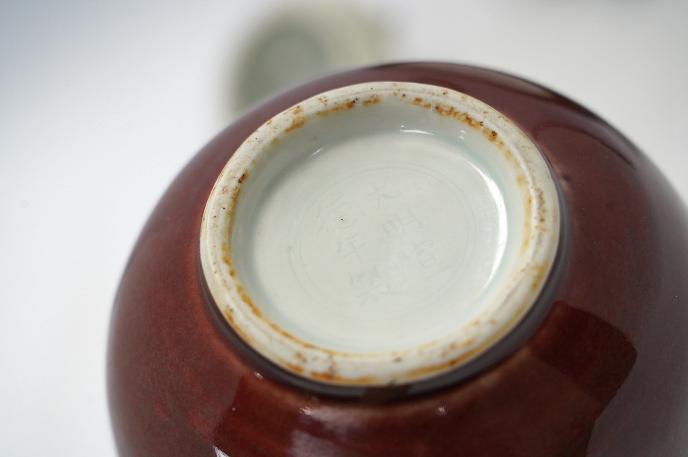 A Chinese famille noire ‘dragon’ dish, 22.5cm diameter, and a Sang de boeuf glaze monk’s cap ewer, Condition - good